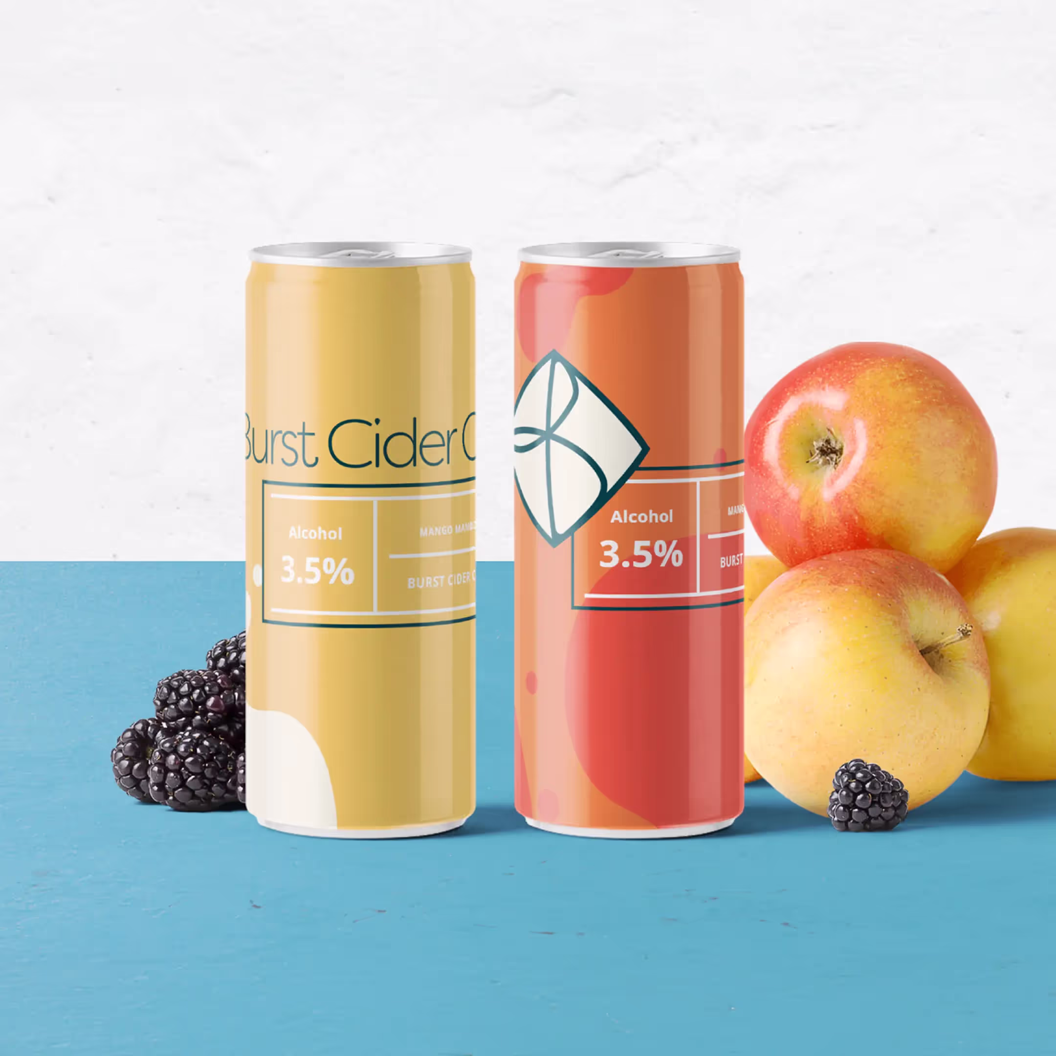 Two cans of Burst Cider, one yellow with mango flavor and one orange with apple flavor, both containing 3.5% alcohol, are displayed on a blue surface with blackberries and apples.