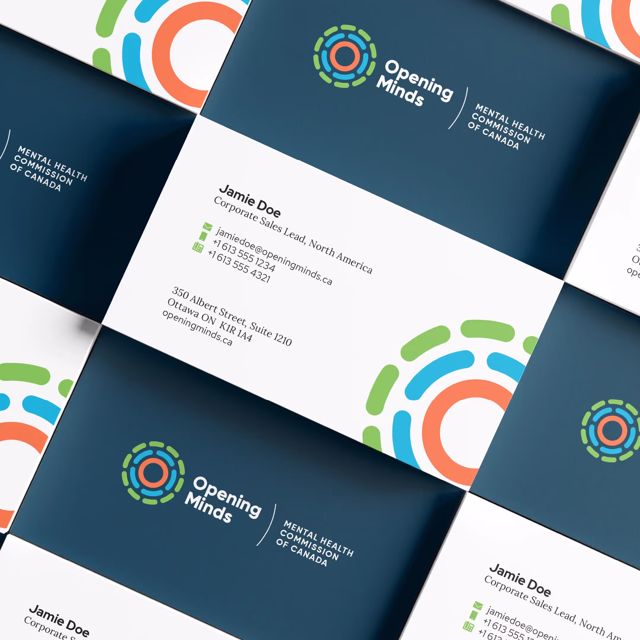 A mockup of the Opening Minds business cards, situated in a repeated isometric grid